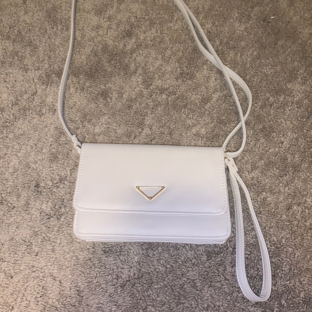 Beige crossbody bag, adjustable strap, removable wristlet.